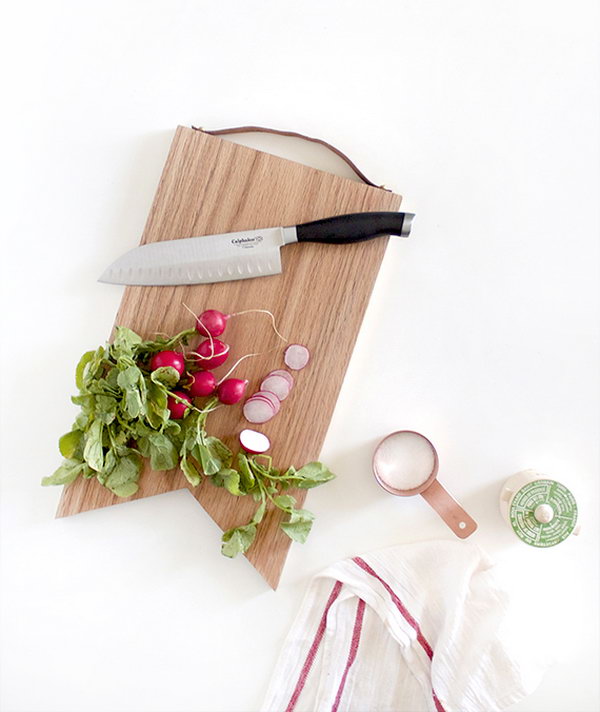 Leather Handled Cutting Board.  The leather handle adds an extra dash of classiness to your cutting board and will definitely come in handy when you're moving around the kitchen or if you want to hang it to display your mad woodworking skills. Get the tutorial 