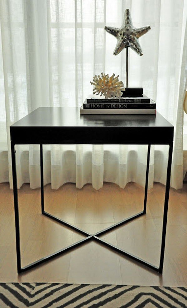 This creative welded table was made with the wood tabletop from an IKEA LACK table and the X shaped metal frame as the table legs. 