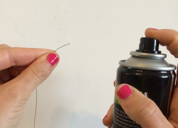 Use hairspray to get that needle through the hole easily